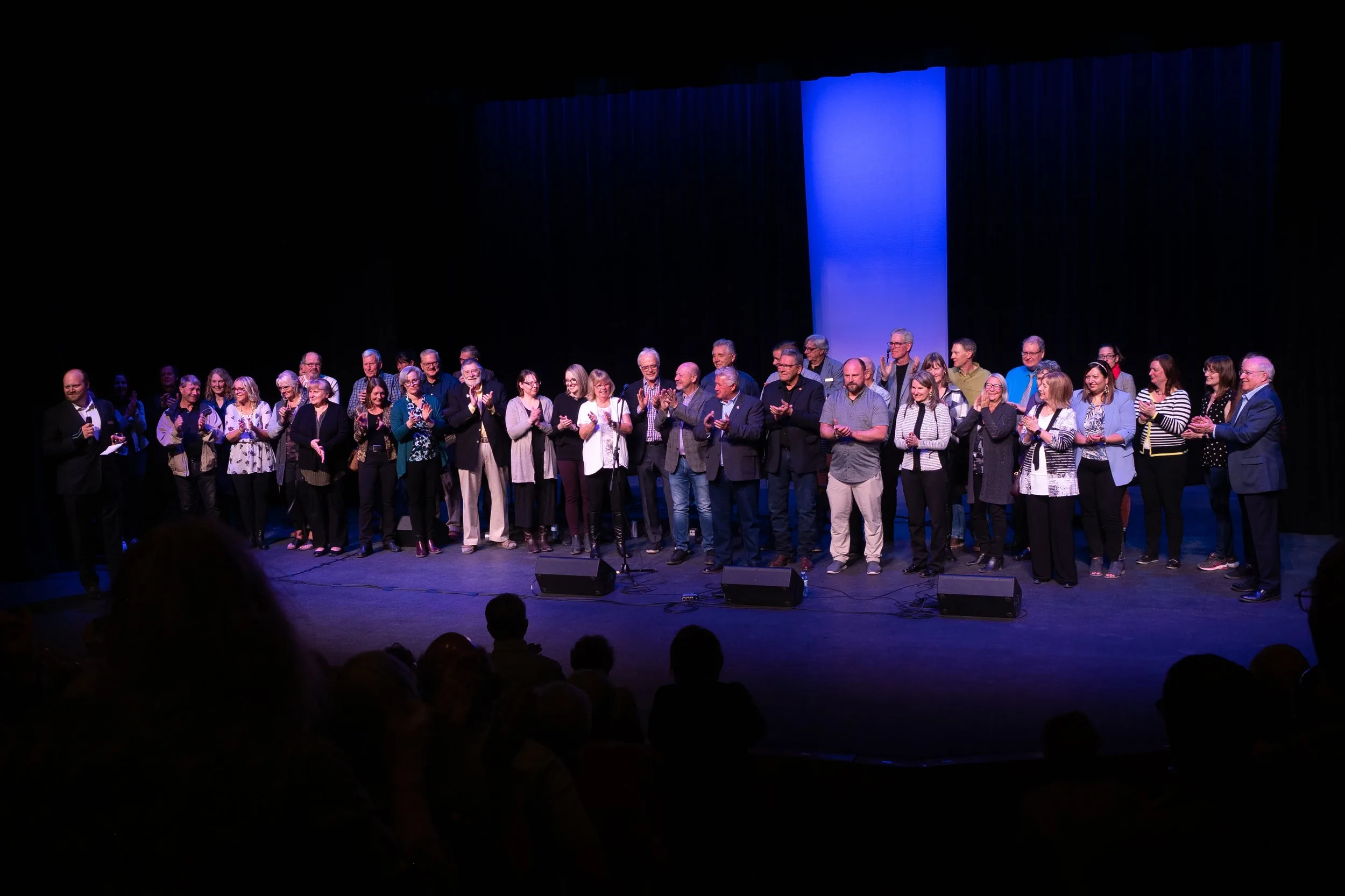 Cast on stage taking a bow in front of a full Key City Theatre house