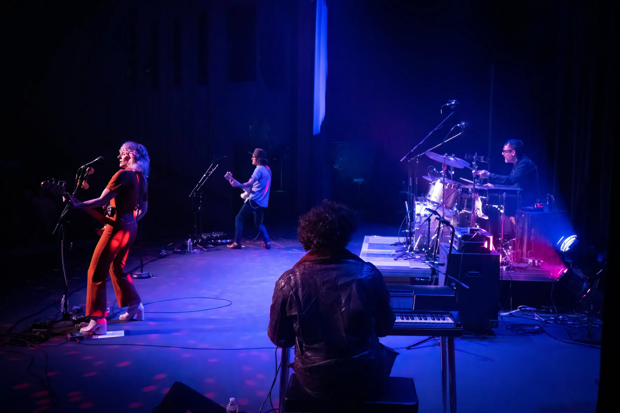 Band performing under stage lights on the Key City Theatre main stage
