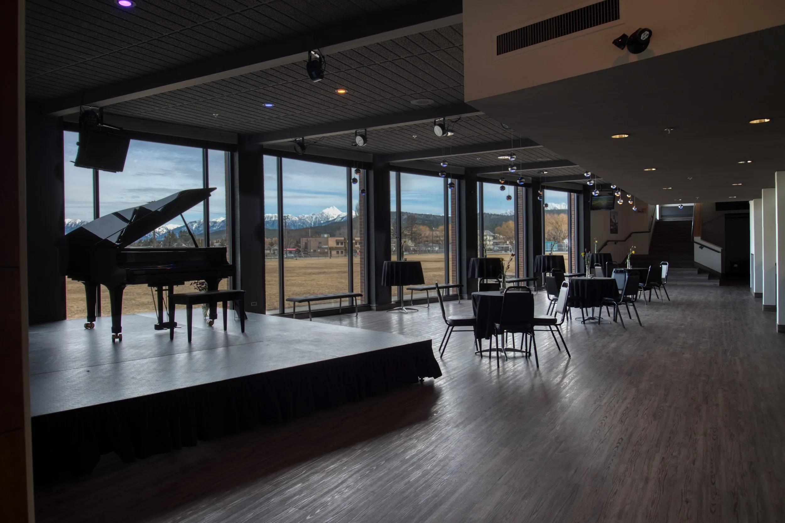 Grand piano beside the tall windows of the Key City Theatre studio hall