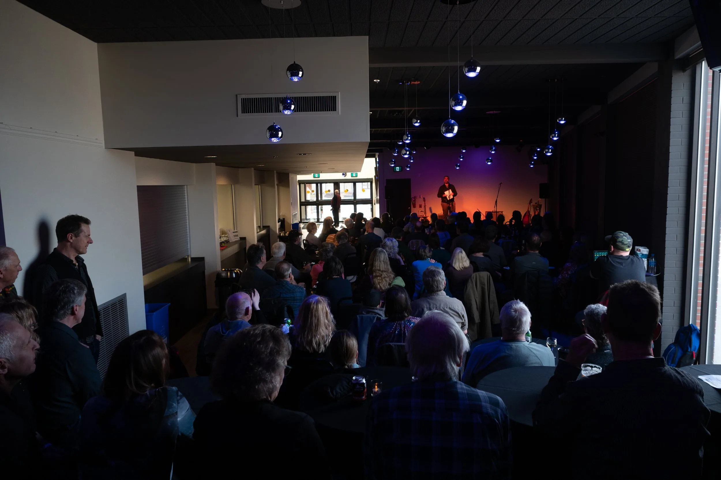 Studio theatre audience viewed from the back of the room